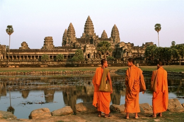Monks prepare to watch the sunset at the main temple of Angkor Wat.