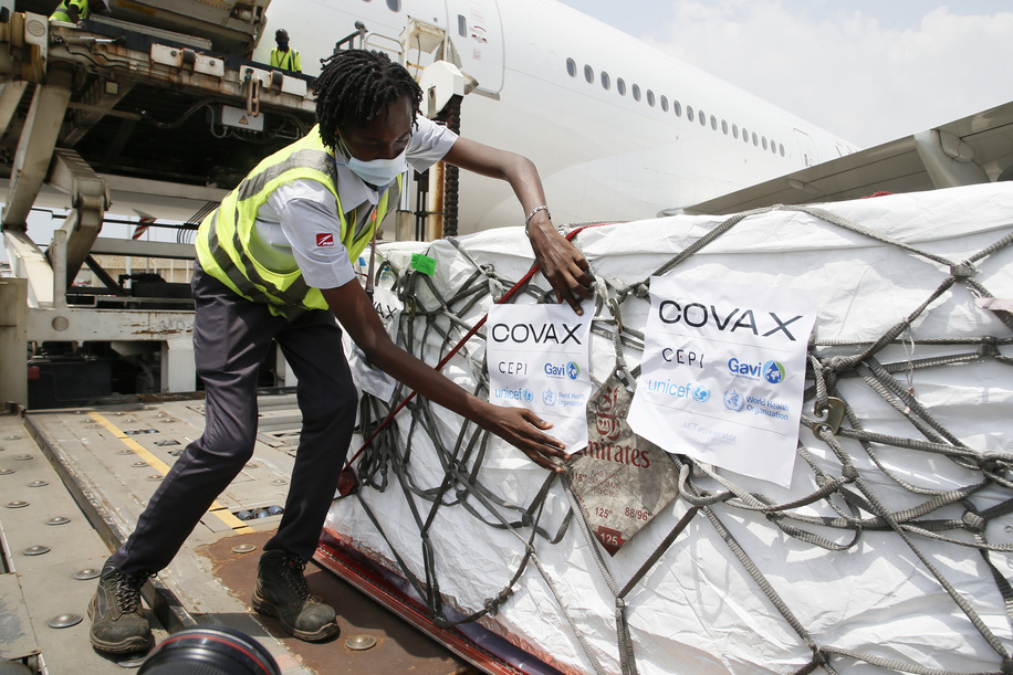 Workers offload boxes of AstraZeneca/Oxford vaccines as the country receives its first batch of coronavirus disease (COVID-19) vaccines under COVAX scheme, in Abidjan, Ivory Coast February 26, 2021. <br><br>504 thousand doses of the Astrazeneca / Oxford vaccine were received in Abidjan. Vaccination against COVID-19 begins March 1 in Côte d'Ivoire