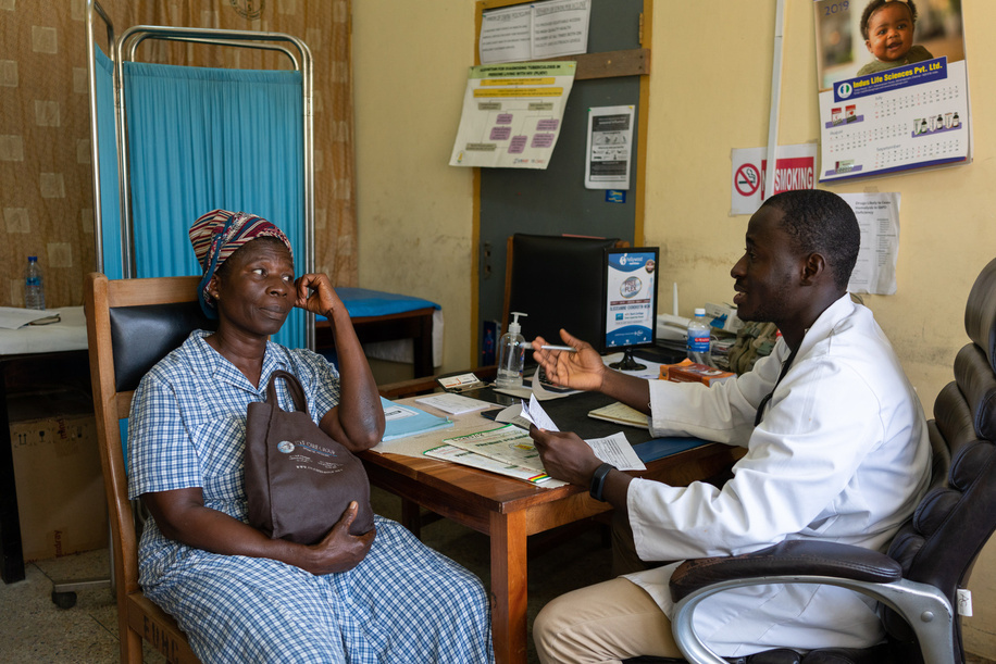 A medical herbalist interacts with a client.